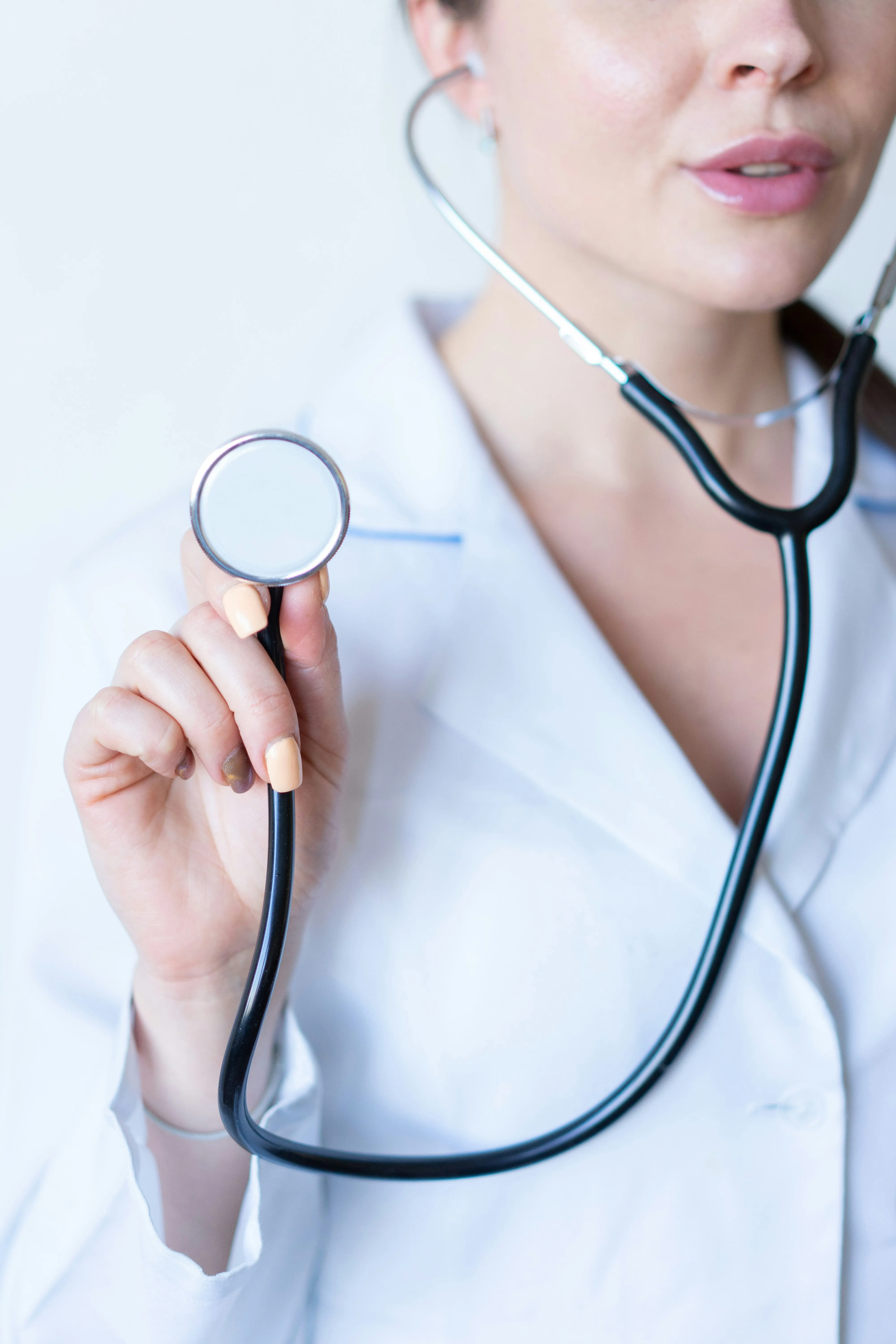Clinician holding out the head of a stethoscope